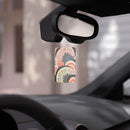 Eco-friendly car air fresheners hanging from rearview mirror with colorful abstract design