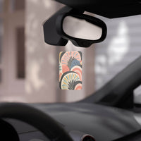 Eco-friendly car air fresheners hanging from rearview mirror with colorful abstract design