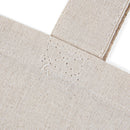 eco-friendly paw print tote bag natural canvas closeup showing reinforced strap stitching and textured fabric