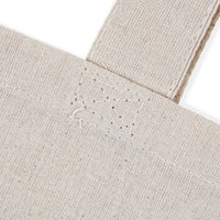 eco-friendly paw print tote bag natural canvas closeup showing reinforced strap stitching and textured fabric