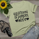 Printify sage green tee laid flat with Girlfriend Fiance Wife text and sunflower props eco-friendly women's relationship tee