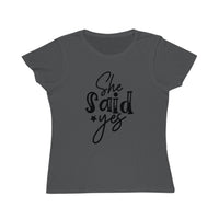 Printify dark gray T shirt with black She Said Yes script print eco-friendly women's engagement shirt