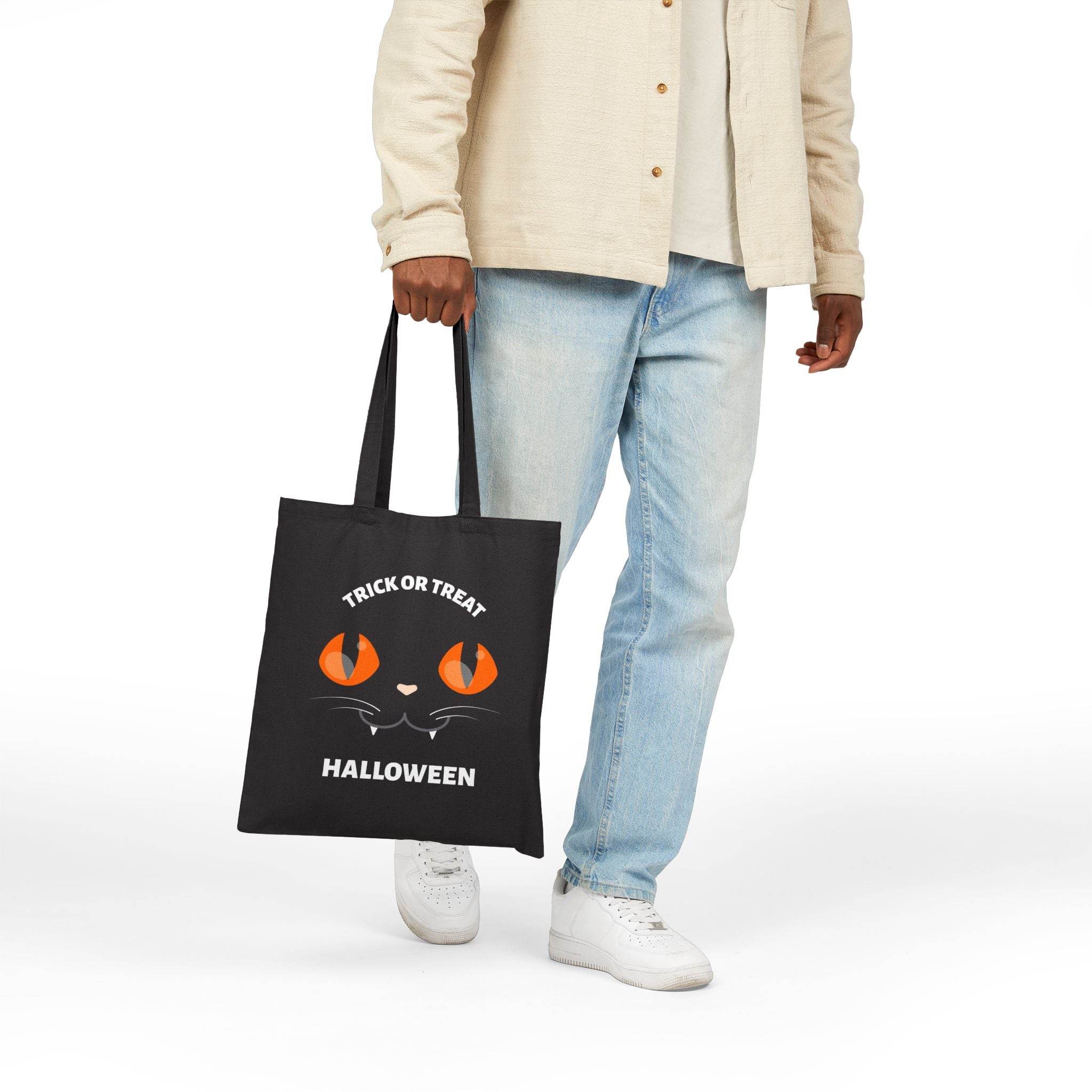 Printify eco-friendly Halloween tote bag with black cat eyes and trick or treat text
