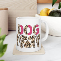 White eco friendly ceramic dog mom mug with leopard print DOG MOM lettering and pink accents on countertop