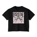 Printify black cropped tee with pink square and silver bow graphic reading BRIDE eco-friendly bridal t-shirt