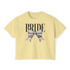 Printify pale yellow cropped T shirt reading BRIDE with large silver bow graphic on front eco-friendly bridal t-shirt