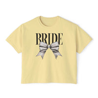Printify pale yellow cropped T shirt reading BRIDE with large silver bow graphic on front eco-friendly bridal t-shirt