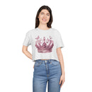 Woman wearing a white Petal & Crown eco crop shirt with a pink crown and butterfly design