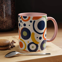 Printify pop art coffee mug with colorful abstract circle patterns and pink handle on wooden table
