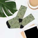 Printify recycled poly socks with green leaf pattern and black heel and toe on white background