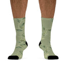 Printify green leafy design recycled poly socks with black toe and heel on male legs