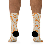 Printify recycled poly socks in beige with orange abstract swirl pattern and black heels
