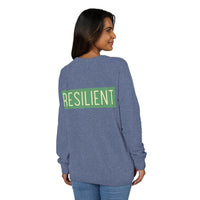 Woman wearing a blue Printify eco-friendly crewneck sweatshirt with resilient text on the back