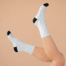White socks with black toe and heel featuring blue snowflake pattern sustainable recycled poly socks from Printify