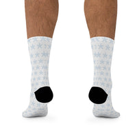 Printify sustainable recycled poly socks with white background and blue snowflake pattern on model feet