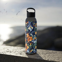 Printify stylish eco water bottle with colorful floral design standing on a stone surface outdoors