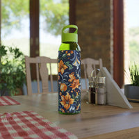 Stylish eco water bottle with floral design and green cap placed on wooden table indoors