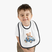 Toddler wearing a Printify sustainable baby bib with a cute teddy bear driving a blue car design