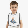 Toddler wearing Printify sustainable baby bib with teddy bear driving blue car design