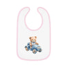 Printify sustainable baby bib with pink trim featuring a teddy bear driving a blue car design