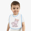 Toddler wearing sustainable baby jersey bib with blue trim and cute hippo design by Printify
