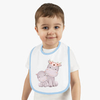 Toddler wearing sustainable baby jersey bib with blue trim and cute hippo design by Printify