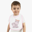 Printify sustainable baby jersey bib with pink trim and cute hippo design worn by toddler