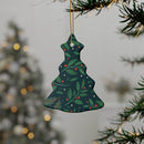 Sustainable ceramic holiday decorations shaped like a Christmas tree with leaf and berry design hanging on tree
