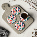 Printify kitchen accessories featuring colorful sustainable drink coasters with leaf patterns on a wooden board