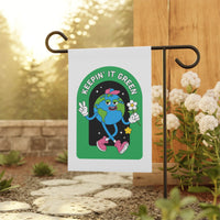 Printify sustainable house flags with Keepin' It Green Earth design on white fabric in garden