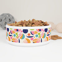 Sustainable pet bowl with a fancy design featuring colorful abstract patterns and filled with dog treats