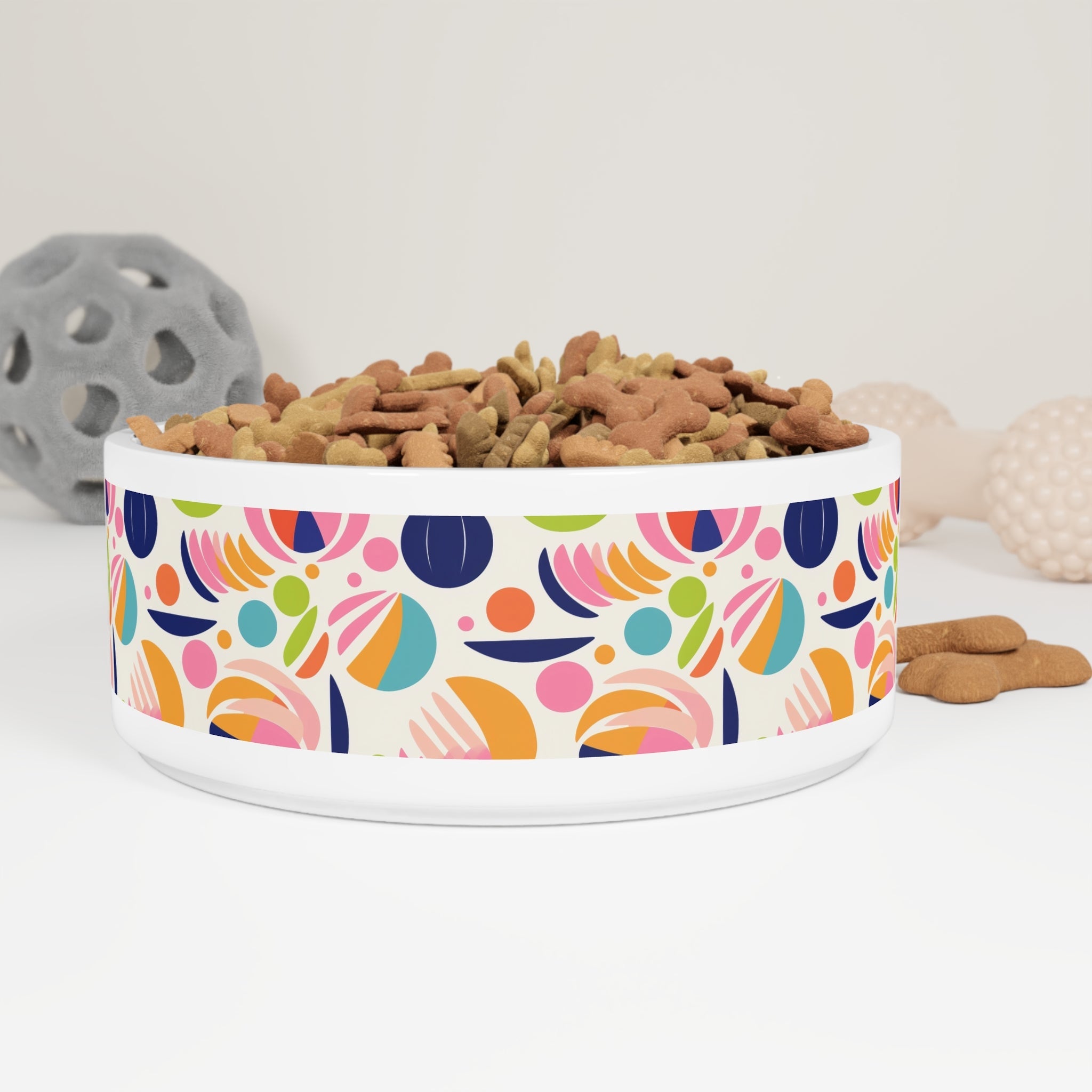 Sustainable pet bowl with a fancy design featuring colorful abstract patterns and filled with dog treats