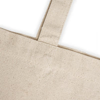 Close-up of natural fabric teacher canvas tote bag strap and stitching detail from Printify