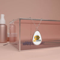 Printify eco-friendly bee necklace with silver chain and bee cool pendant on glass display