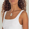 Woman wearing Printify eco-friendly bee necklace with silver chain and bee pendant in white top