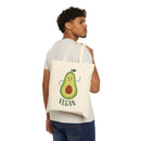 Man carrying eco-friendly cotton tote bag with a cute vegan avocado design printed on the front