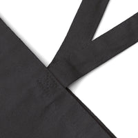 Close-up of black eco-friendly cotton tote bag strap showing durable stitching