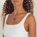 Woman wearing eco-friendly ghost necklace with pink ghost design on silver chain from Printify