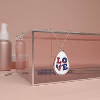 Printify eco-friendly love necklace with patriotic love design displayed on clear stand