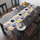 Printify eco-friendly table runner with colorful abstract design on dark wood dining table
