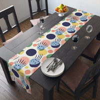 Printify eco-friendly table runner with colorful abstract design on dark wood dining table