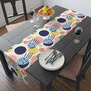 Printify eco-friendly table runner with colorful abstract pattern on dark wooden dining table