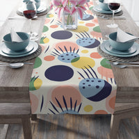 Printify eco-friendly table runner with colorful abstract floral design on wooden dining table